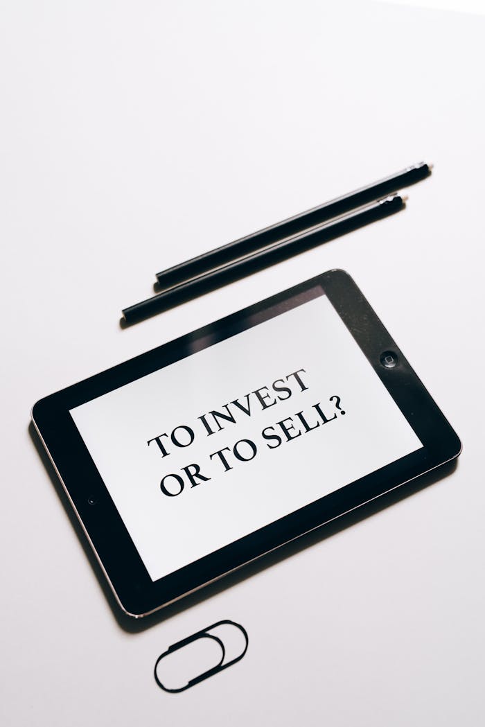 about-01 Tablet displaying To Invest or To Sell? question, symbolizing investment decisions.